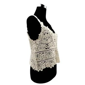 Side detail of cream cotton crochet lace vest featuring intricate hollow embroidery patterns