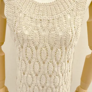 Close-up of apricot sleeveless top with intricate geometric crochet texture
