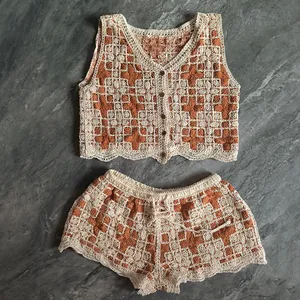 Detailed flat lay of bohemian crochet two-piece set with vest and drawstring shorts.