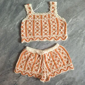 Detail of boho crochet two-piece set with orange diamond knit pattern