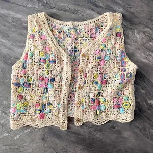 Close-up of Bohemian hollow out crochet floral knit vest cardigan with wooden buttons