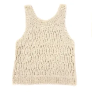 Detailed macro view of apricot knit sleeveless top featuring intricate hollow geometric patterns.
