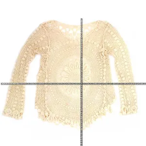 Detailed view of cream cotton hollow lace cover-up showing size measurements with a tape