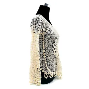 Side view detail of beige crochet lace long sleeve top showing intricate hollow patterns