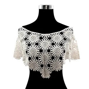 Intricate white sunflower pattern lace crochet shawl displayed on a professional mannequin