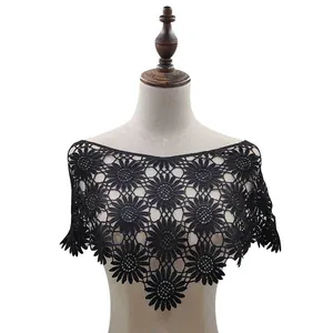 Detailed view of a black floral lace crochet shawl on a female mannequin torso