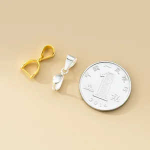 Close-up of gold and silver plated 925 sterling silver pinch bails next to a coin