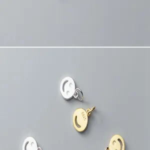 Macro view of S925 sterling silver and gold-plated smiley face charms for DIY jewelry making