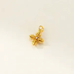 Detailed macro view of a golden 925 silver Vajra pendant with inlaid stone.