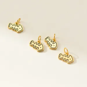 Detailed view of gold-plated fishbone charms with black engraved outlines