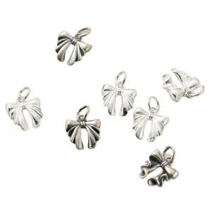 925 sterling silver vintage bow knot charms for DIY jewelry making scattered on white background