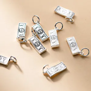 Detailed view of sterling silver miniature $100 bill charms for DIY jewelry making