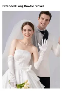Elegant long white satin bridal gloves with bow details shown on a wedding bride