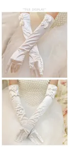 Detail view of long white satin bridal gloves featuring elegant double bow knots