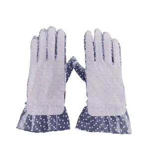Elegant white polka dot mesh gloves for women featuring a romantic sheer ruffle cuff