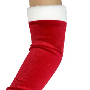 Detailaufnahme von roten Weihnachts-Armstulpen aus Samt mit weißem Kunstpelzbesatz.
