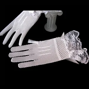 Detailed close-up view of white fishnet bridal gloves featuring elegant lace ruffles.