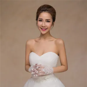 Detailed close-up of elegant short bridal lace gloves with mesh and floral embroidery patterns