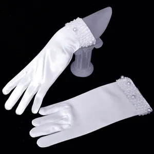 Close-up view of elegant white satin bridal gloves featuring beaded pearl cuffs for wedding