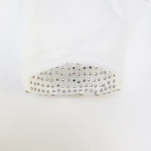 Detailed view of exquisite silver rhinestones on white satin bridal glove cuff