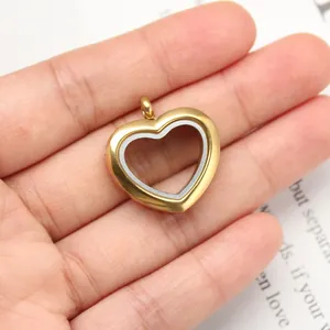 Close-up detail view of a gold-plated stainless steel heart locket pendant on hand