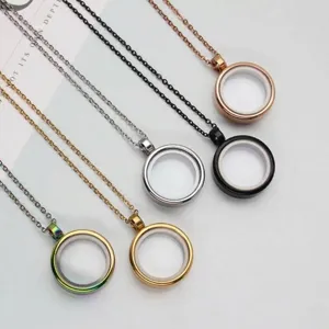 Close-up of circular stainless steel locket pendants in various metal finishes.