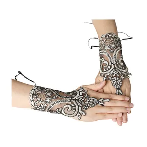 Intricate floral lace fingerless bridal gloves with ribbon tie for wedding accessories