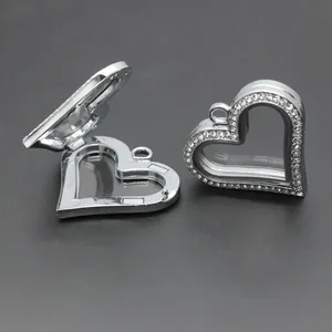 Detail view of silver heart-shaped rhinestone glass locket pendant shown open and closed