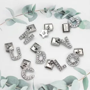 Close-up detail of stainless steel Italian modular charms with rhinestone alphabet letters