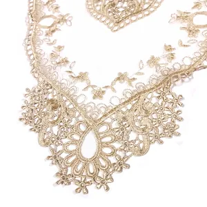 Detailed view of intricate golden floral lace embroidery with French heart motif on mesh