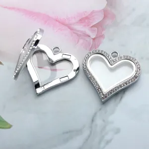 Detailed macro view of a silver heart-shaped locket pendant featuring sparkling rhinestones