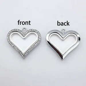 Front and back view of a silver heart-shaped glass locket pendant with rhinestones.