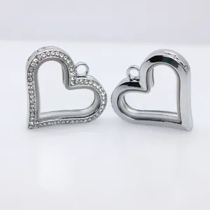 Detailed view of heart-shaped alloy locket pendants with glass windows and rhinestones.