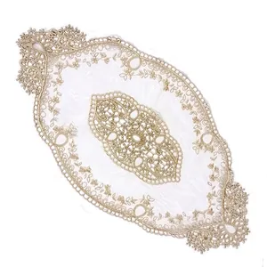 Detailed view of elegant French style lace embroidered mat with gold floral patterns