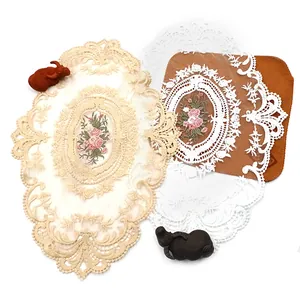 Nahaufnahme von ovalen Spitzen-Platzsets mit eleganten rosa Blumenstickerei-Details.