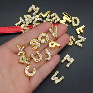 Close-up detail of 10mm gold-plated rhinestone alphabet slide charms for DIY jewelry design