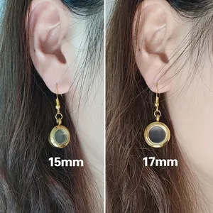 Nebeneinander Vergleich von 15mm und 17mm goldenen runden Medaillon-Ohrringen am Ohr getragen