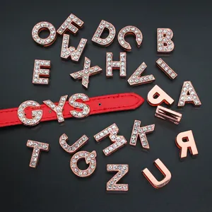 Detailed view of 10mm rose gold rhinestone letter charms on a red leather wristband