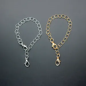 Detail of gold and silver metal chains with dual lobster clasps for accessories