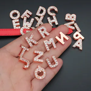 Detailed close-up of 10mm rose gold rhinestone alphabet slide charms for DIY jewelry making.
