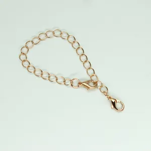 Close-up of a light gold finished jewelry chain with two lobster clasps for DIY crafts