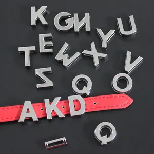 Detail view of 10mm silver zinc alloy alphabet slide charms on a red leather strap