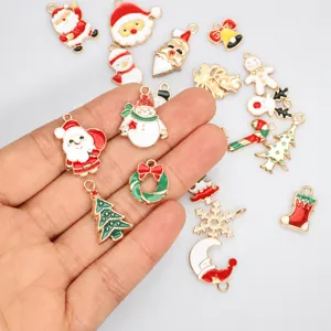 Detailed view of various Christmas enamel charms including Santa and snowmen for DIY
