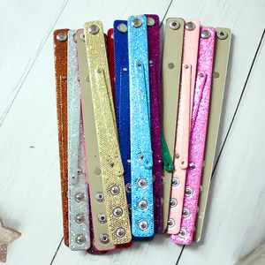 Close-up of colorful glitter sequin DIY snap wristbands in multiple vibrant shades