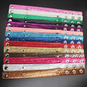 Detailed view of multiple colored glitter double-layer wristbands with snap buttons