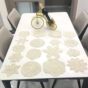 Detailed view of various beige handmade crochet lace coasters in different unique patterns