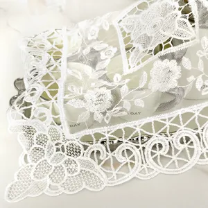 Detailed view of white floral lace embroidered mesh cover with scalloped edges for home decor