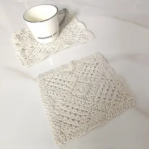 Detailed texture of hand-crocheted vintage lace coaster in cream white soft cotton fabric
