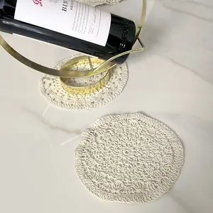 Macro detail of a vintage hollow embroidery lace coaster on a marble surface decor