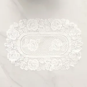 Elegant close-up of white water-soluble lace placemat with intricate rose embroidery
